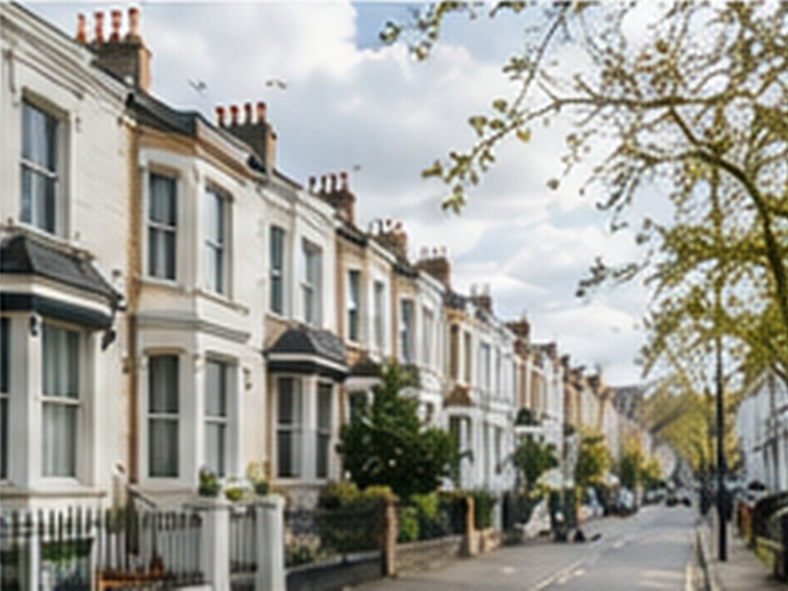 A street of white-fronted Victorian terraced houses